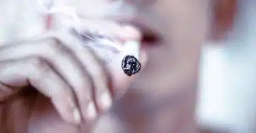 selective focus of man hitting cigarette